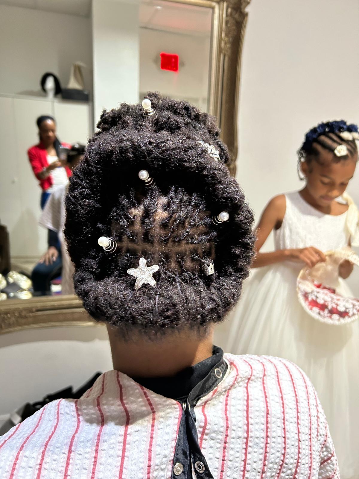 Young client's crown locs beautifully decorated with white stars and shells
