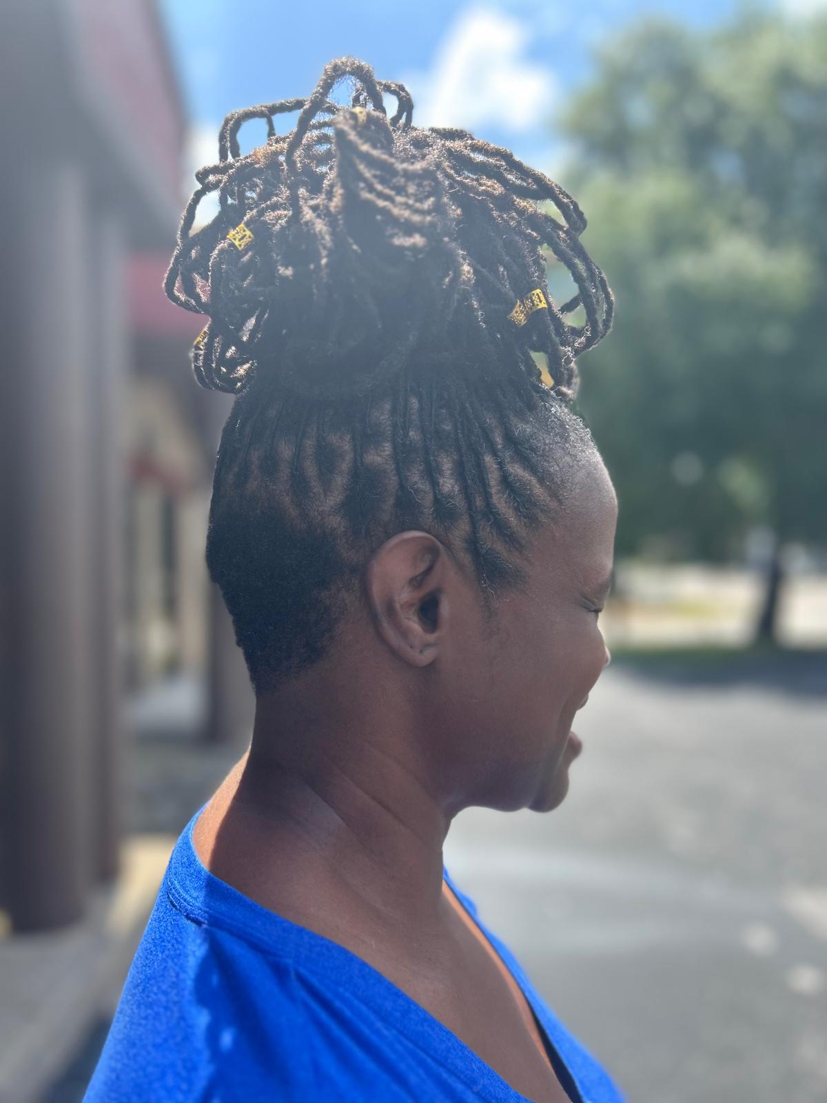 Elegant crown loc updo adorned with golden accessories showing styling possibilities
