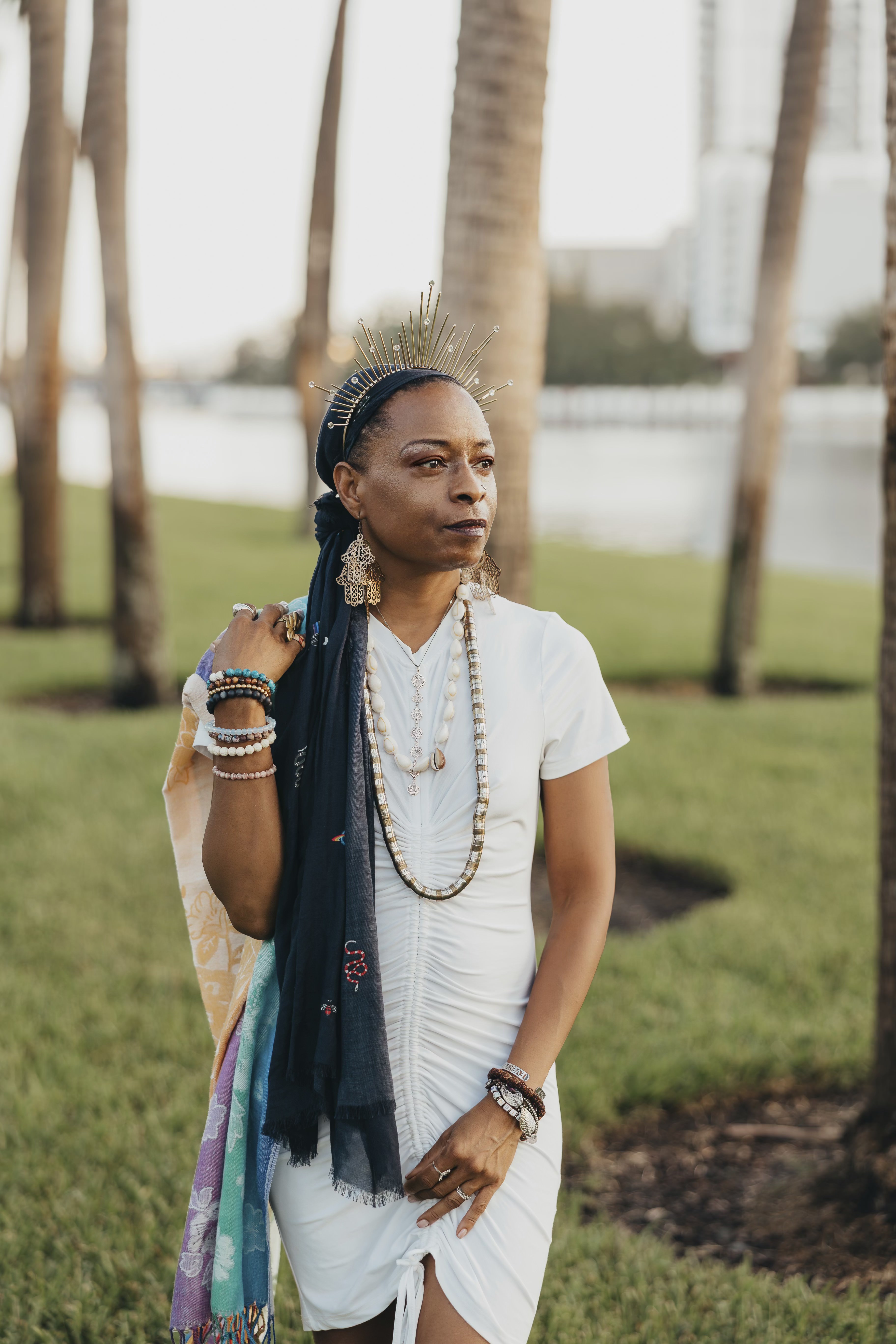 Sabrina, founder of Zemi Locs, in a natural outdoor setting with trees and grass, showcasing the serene and grounded nature of our holistic practice