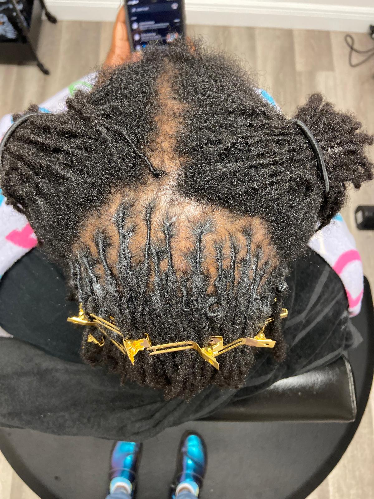 Professional starter crown locs formation process with golden sectioning clips showing technical precision